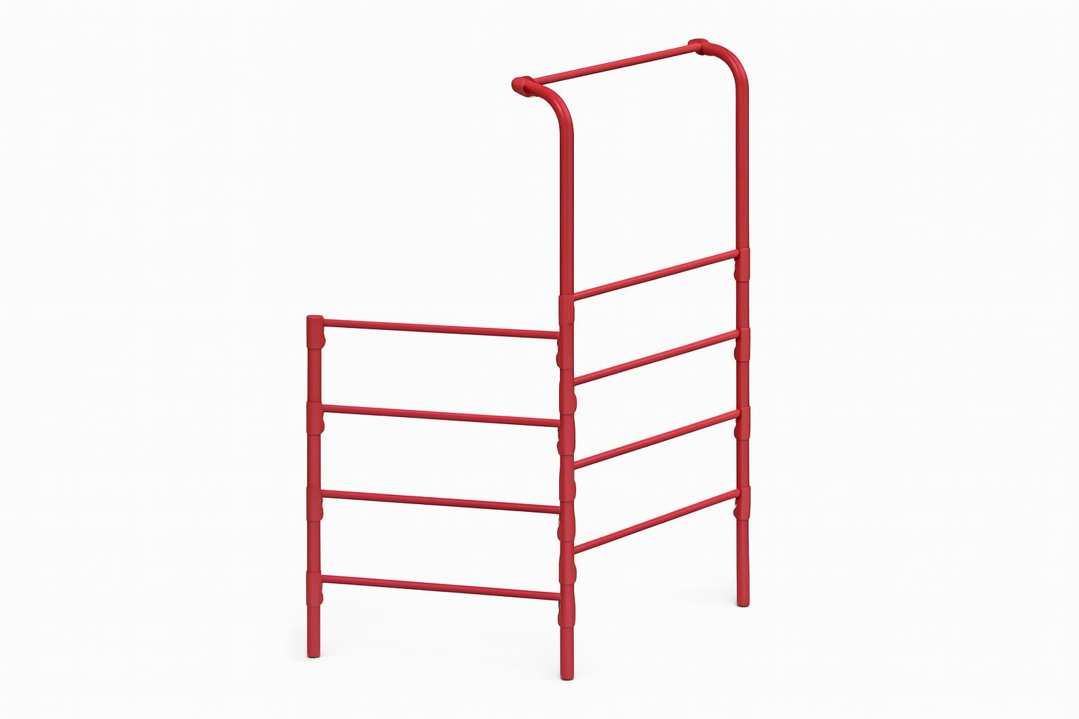 Red metal climbing frame with horizontal bars, two children playing on wood chip ground in a natural outdoor setting