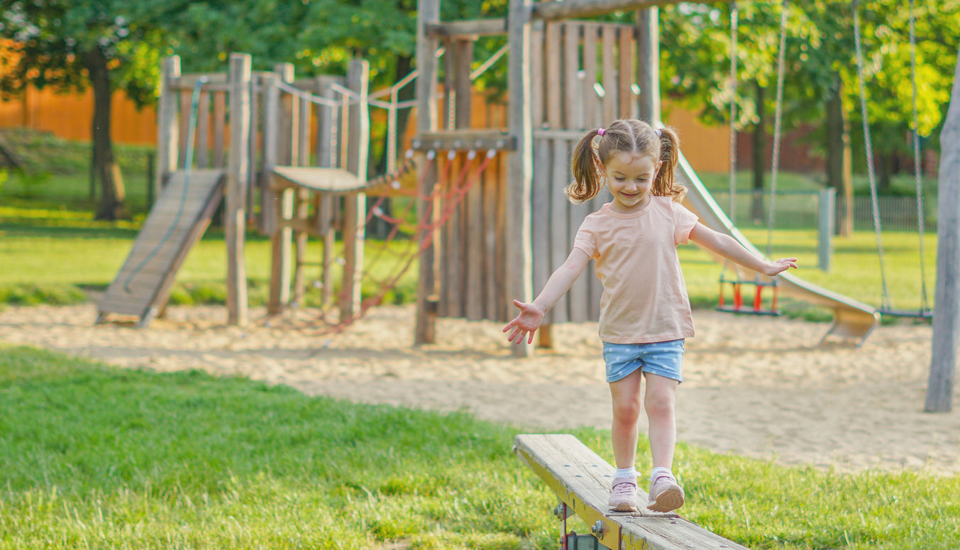 Girl Playing on Playground Balance Beam