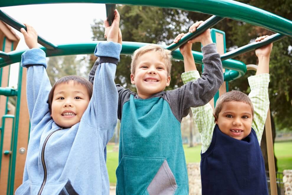 Kids Playing on Monkey Bars Playground at Park