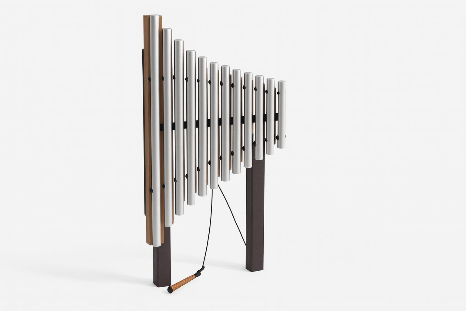 Griffin Outdoor Musical Park Instrument with anodized aluminum chimes, tan frame, set outdoors near trees and water