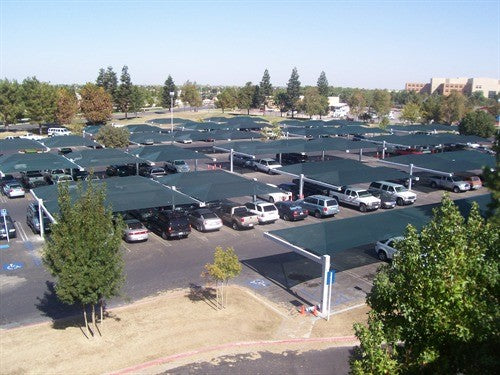 A parking lot filled with heavy duty commercial shade structures designed for pools.